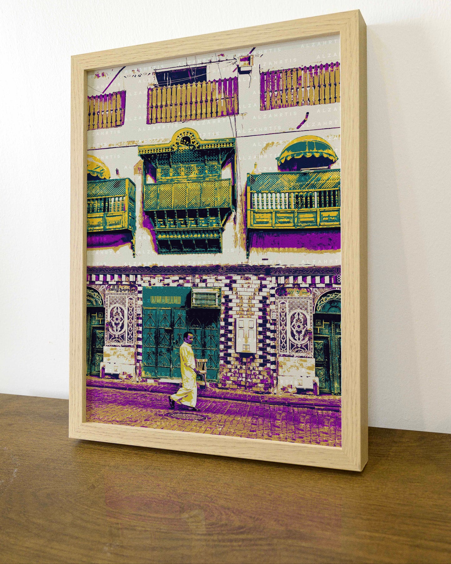 Framed artwork of a colorful architectural scene with a person walking on a wooden floor.