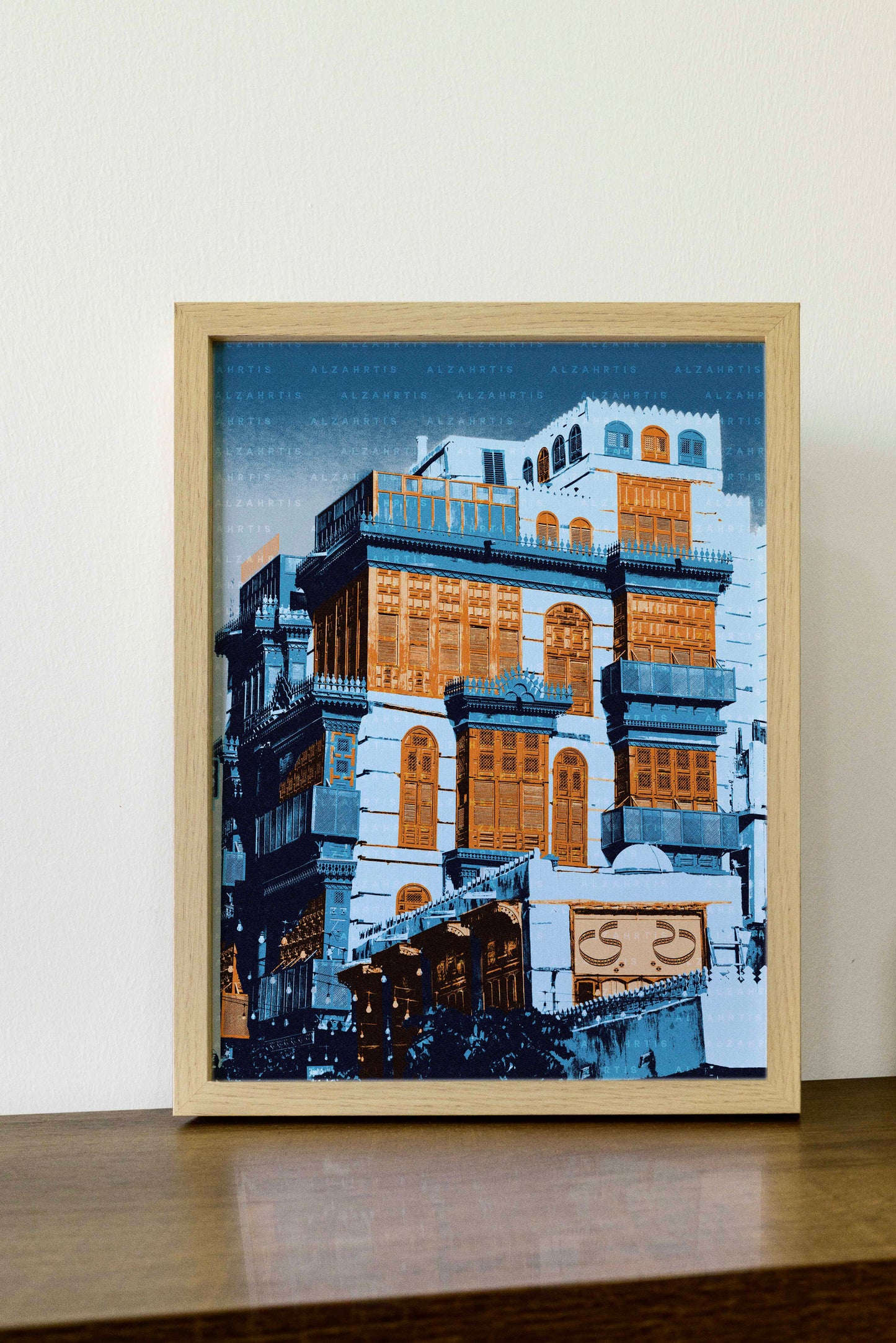 Framed artwork of a building with wooden shutters on a white wall.