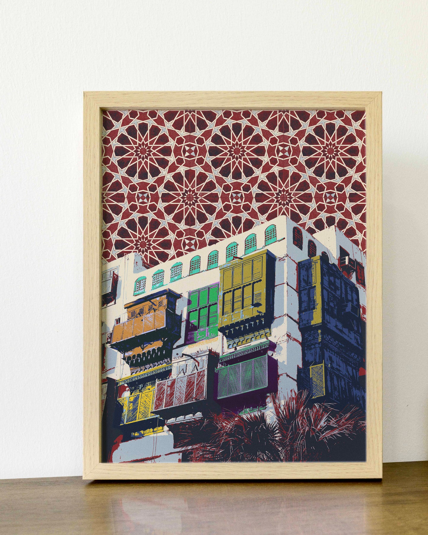 Framed artwork of a building with decorative patterns on a white wall.