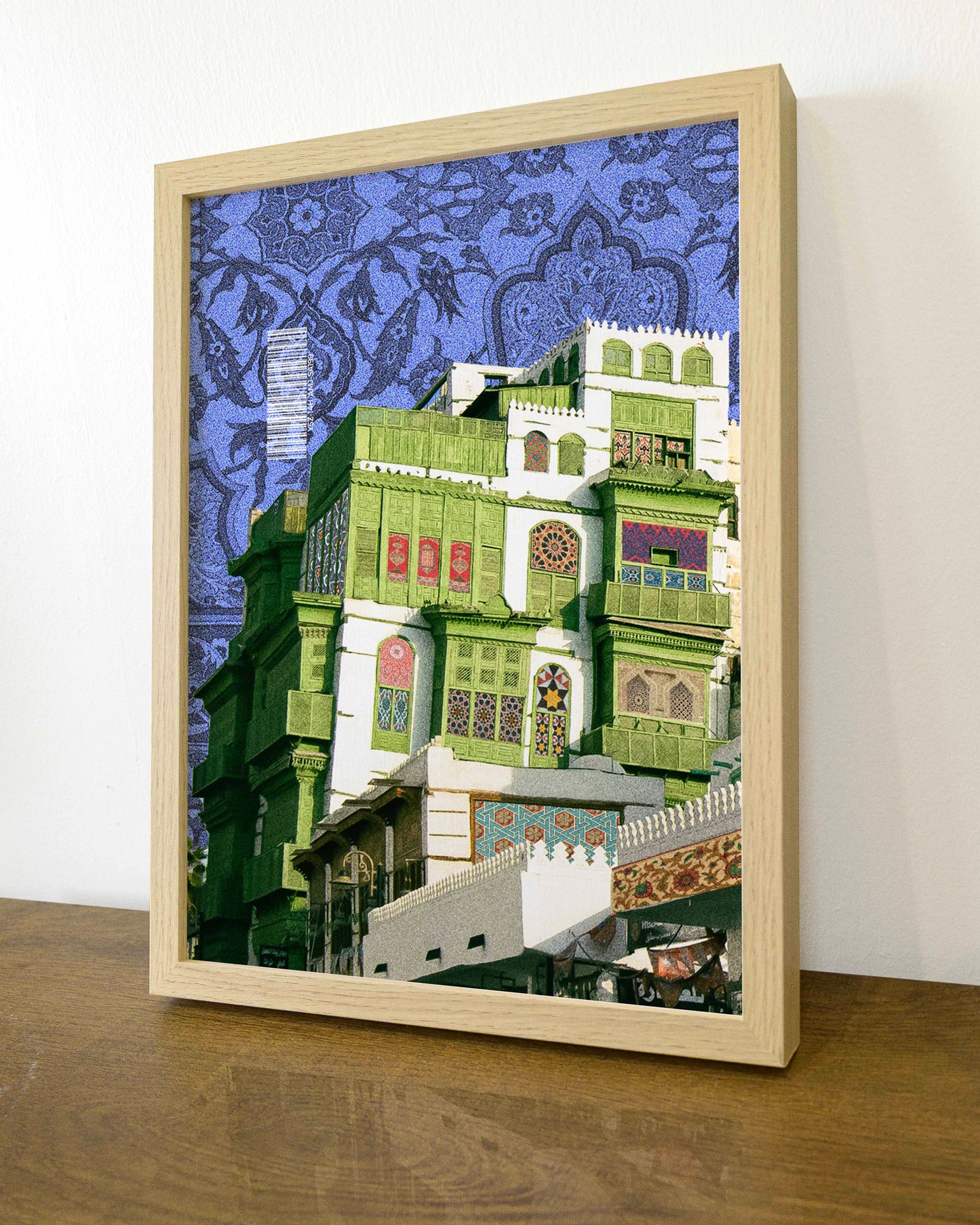 Framed Decorative collage of a Al Balad building with intricate patterns on a blue background. Printed Artwork