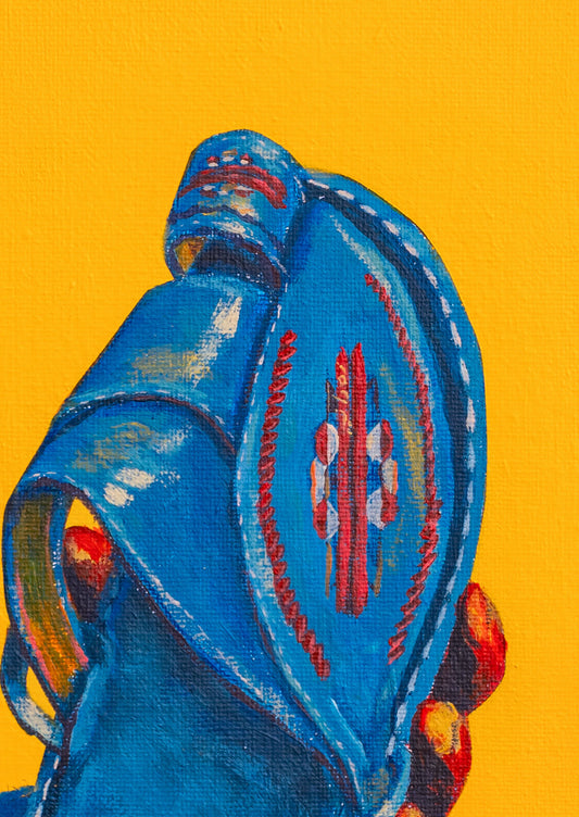 Blue decorative item with red and white patterns on a yellow background